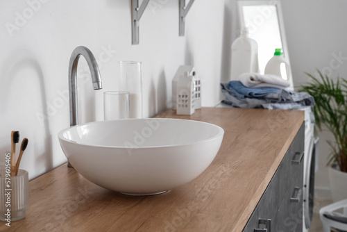 White sink on counter in light bathroom