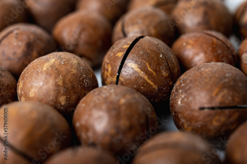 ight background  macadamia nuts close-up on a light surface  tasty nut healthy nutrition  food.