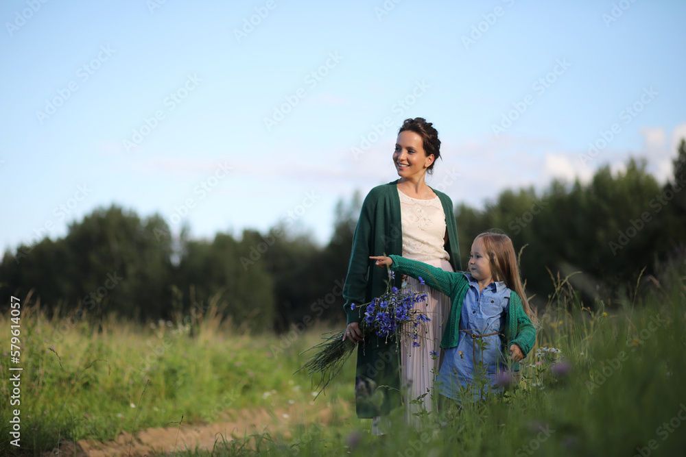 Mother with daughter walking on a road Mother with daughter walking on a road