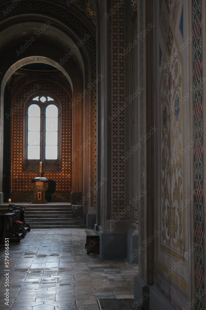 Monumental church building in Gothic in neo-romanesque arch style with large ceiling and altar murals and fresco, opulent detailed columns and marble structures