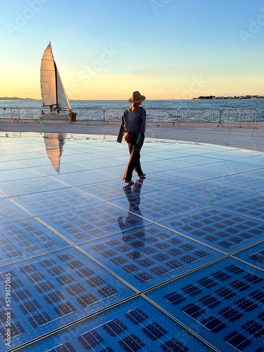 rear view of woman walking over solar panel Greeting to the Sun located at Zadar, Croatia