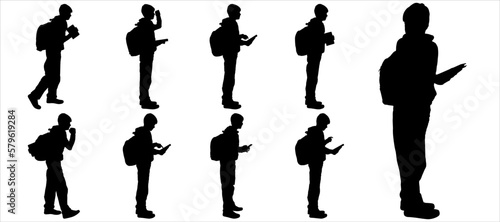 Children with school bags. The students are standing. Pupils. Teenagers with backpacks rush to school. Boys in different poses with bags. Side view. Back to school. Black silhouette isolated on white