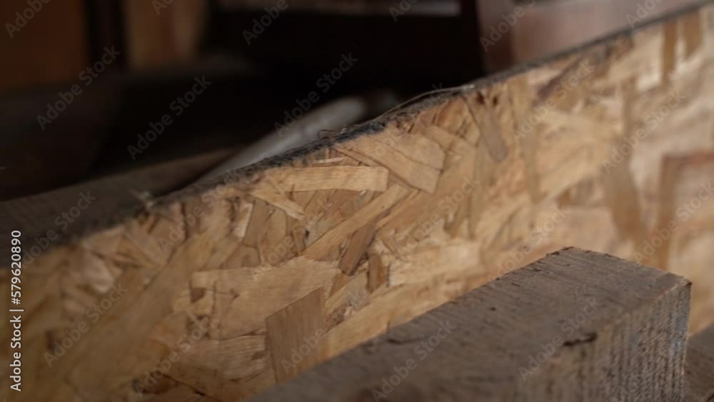 Oriented strand board close-up in a dark room. Camera movement along the osb plate Oriented strand board close-up in a dark room. Camera movement along the osb plate