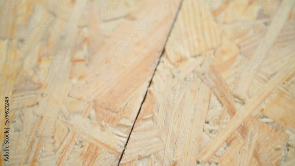 Oriented Strand Board screwed with black selftapping screws closeup
