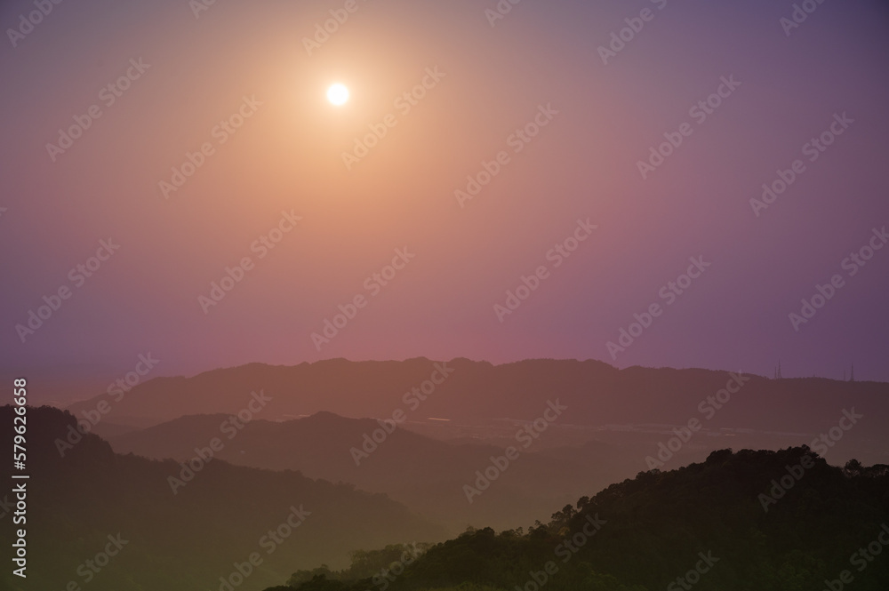 At noon, the sun moves from high above in the direction of the mountains. Hakka-style mountain city scenery, Dahu Township, Miaoli County. Taiwan