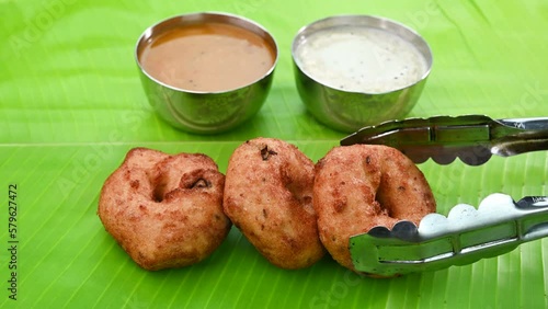 Serving indian snack vada on a banana leaf. photo