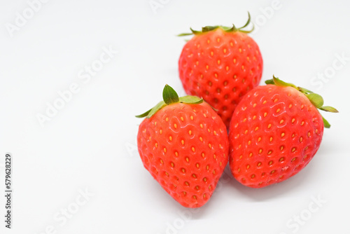 beautiful three fresh red strawberry isolated on white background