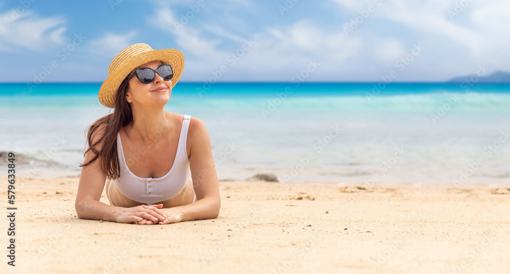Woman lying on the sea beach
