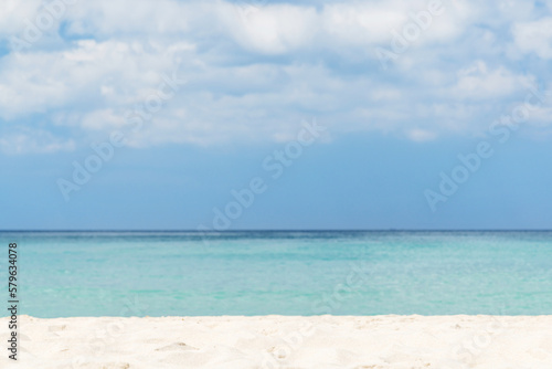 Bright sand beach, sea and beautiful sky with clouds