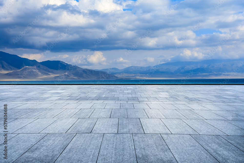Empty square floors and lake with mountain scenery in Xinjiang, China.