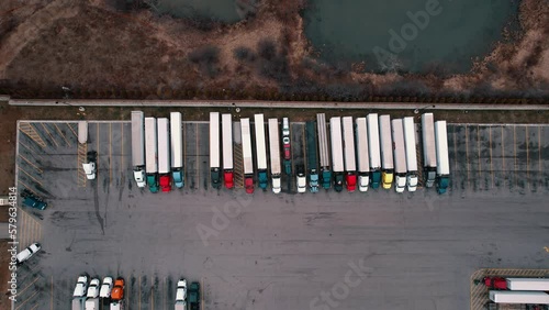 Static aerial of top down truck stop aerial view. Carhauler, dryvan, reefers, flatabed, bobtails parked. USA 4k Aerial photo