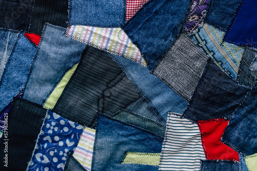 jeans fabric pieces sewn in different shapes and shades fragment, denim patchwork, needlework