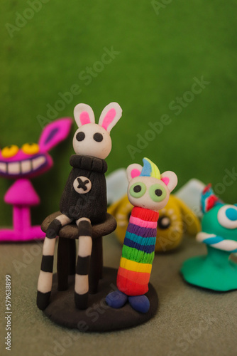 cute cartoon figures from colored airy plasticine, modeling from plasticine by children
