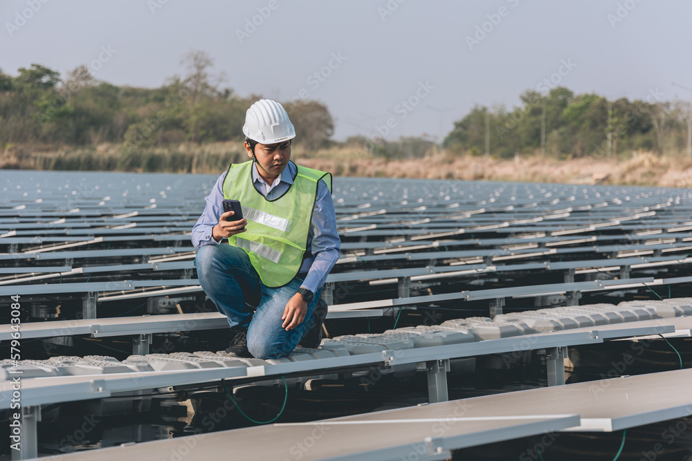 Electrical engineers are using laptops to monitor the operation of the solar rooftop. Renewable energy concepts.