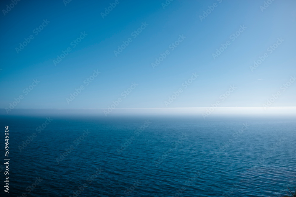 Tranquil view of calm sea against blue sky during summer Tranquil view of calm sea against blue sky during summer