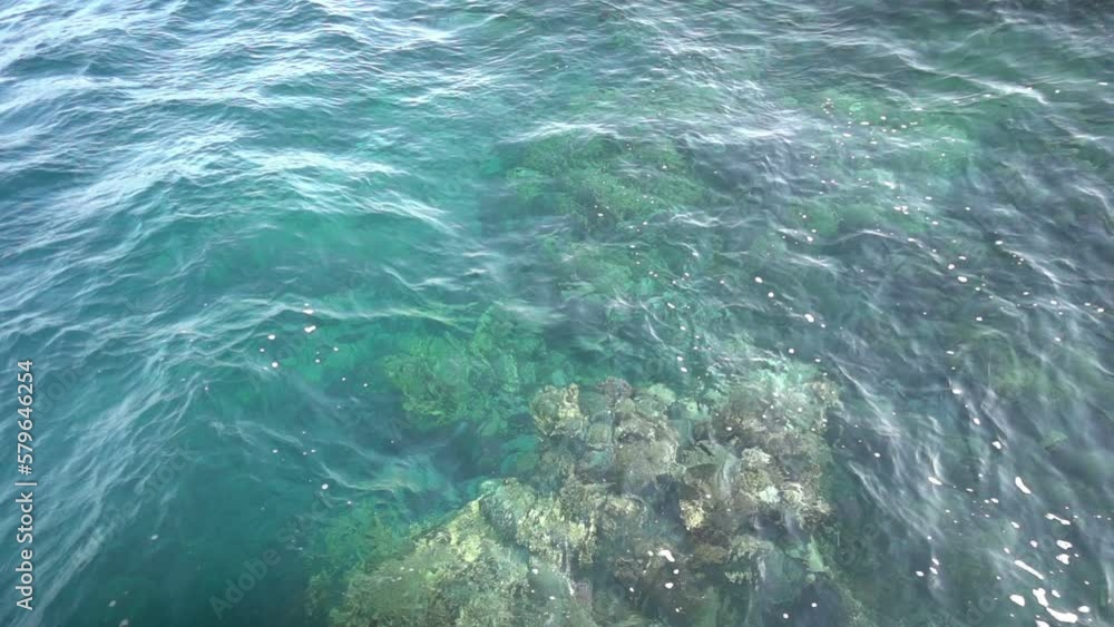 Transparent blue-green sea and waves on rocky corals. Slow motion Transparent blue-green sea and waves on rocky corals. Slow motion