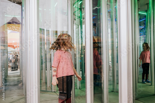 Girl seen through window at amusement park