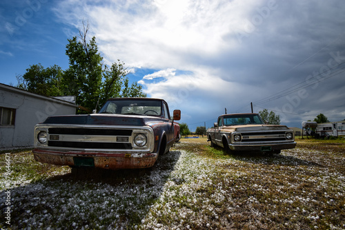 Old pickup trucks with no wheels and a backyard In Colorado photo