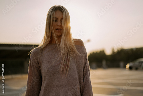 Beautiful young blonde woman with long hair smiling, close-up po photo