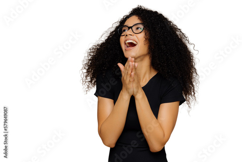 Konstfotografi Overjoyed beautiful woman clasps hands, laughs joyfully, looks away, focused asi
