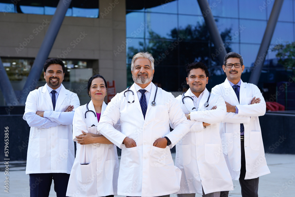 Successful team of medical doctors standing in hospital. Successful team of medical doctors standing in hospital.