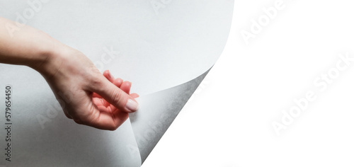 Hand pulling white page to reveal and show your design. Transparent background photo