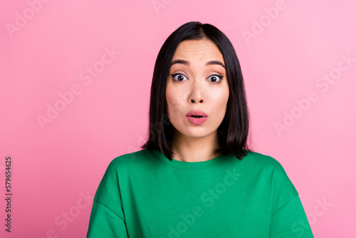 Portrait of shocked speechless vietnamese girl staring cant believe isolated on pink color background