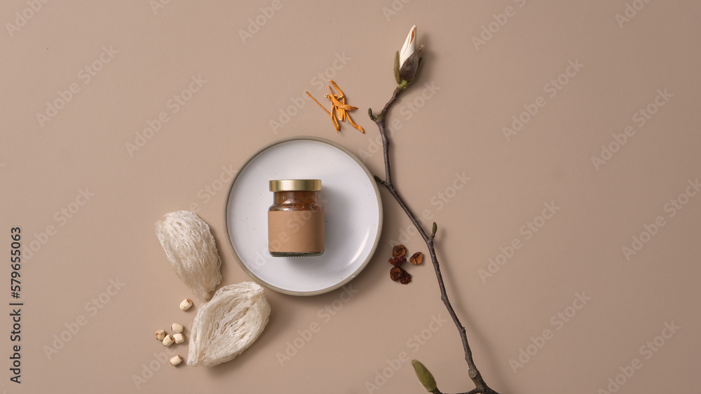 An empty label jar placed on white dish, edible bird’s nest, lotus seeds, cordyceps and jujube putted around. Product mockup. Bird’s Nest is a unique source of traditional Chinese medicine An empty label jar placed on white dish, edible bird’s nest, lotus seeds, cordyceps and jujube putted around. Product mockup. Bird’s Nest is a unique source of traditional Chinese medicine