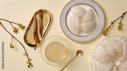 Canvas Print Top view of bird’s nest, bowl soup and red ginseng on beige background