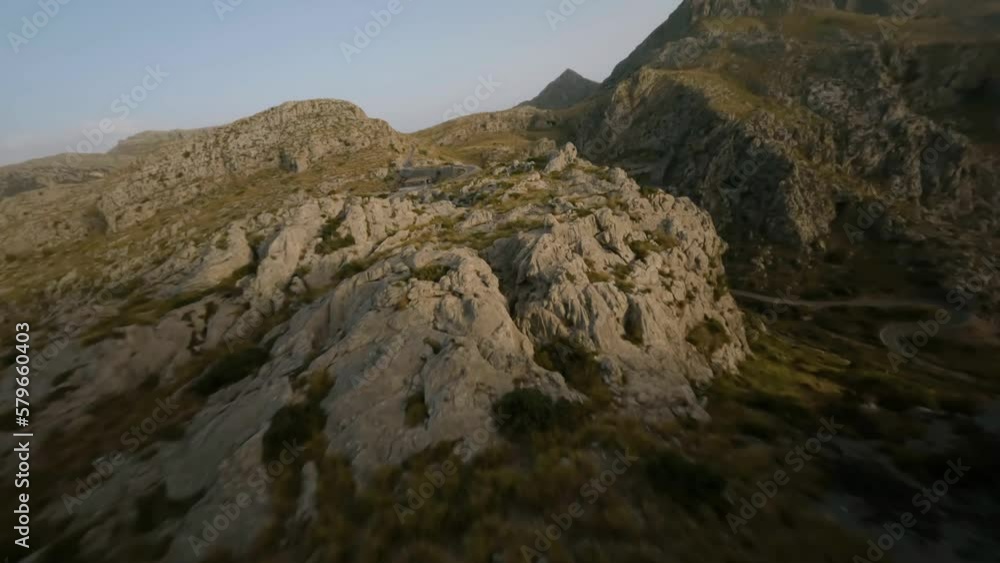 FPV drone forward moving shot over snake road along rocky mountain range in Sa Calobra, Mallorca, Spain during evening time. FPV drone forward moving shot over snake road along rocky mountain range in Sa Calobra, Mallorca, Spain during evening time.