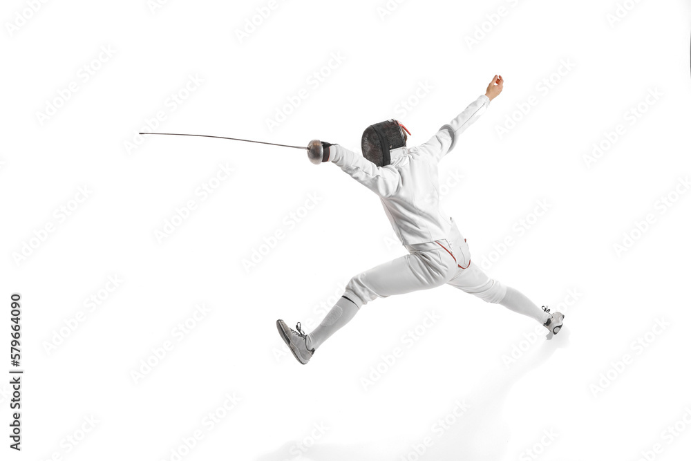 Dynamic portrait of male athlete in fencing costume with sword in hand in action isolated on white studio background. Dynamic portrait of male athlete in fencing costume with sword in hand in action isolated on white studio background.