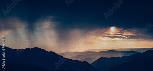 banner of mountain peaks in beautiful stormy sunset light © Melinda Nagy