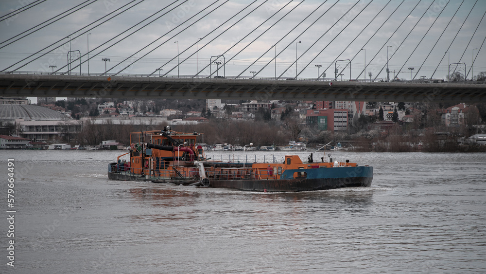 Fototapeta premium A river barge sailing along the river upstream