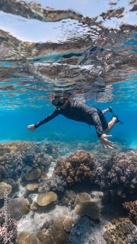 young man snorkeling in the great barrier reef