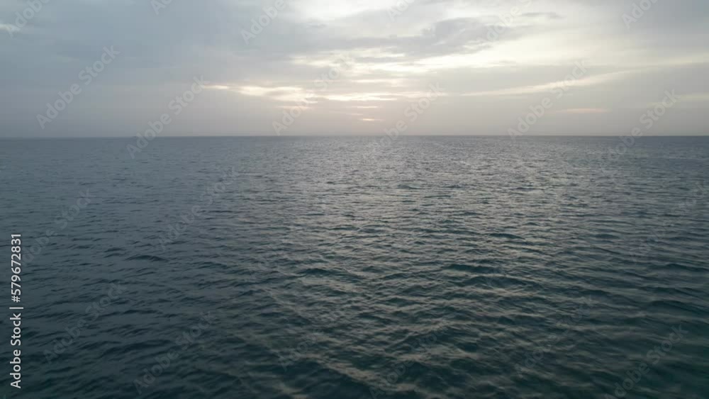 View of the clouds over the sea at sunrise. Blues mix with oranges, golden hour. View of the clouds over the sea at sunrise. Blues mix with oranges, golden hour.