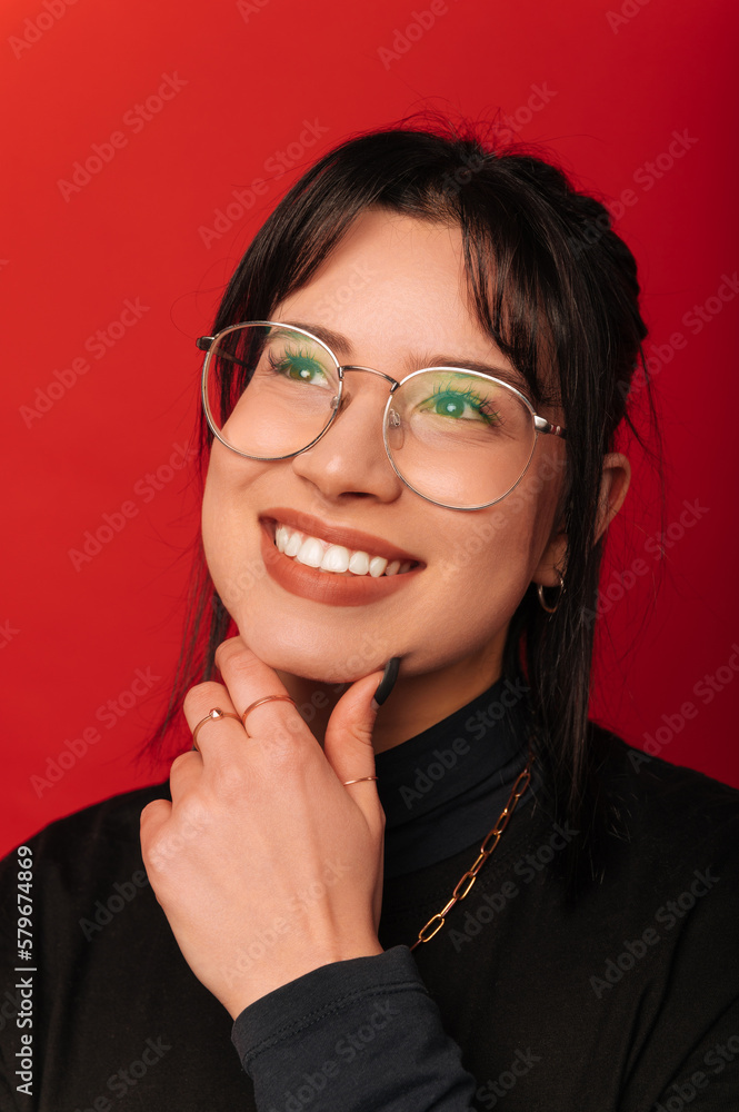 Vertical portrait of a young dreaming woman holding hand near her chin. Vertical portrait of a young dreaming woman holding hand near her chin.