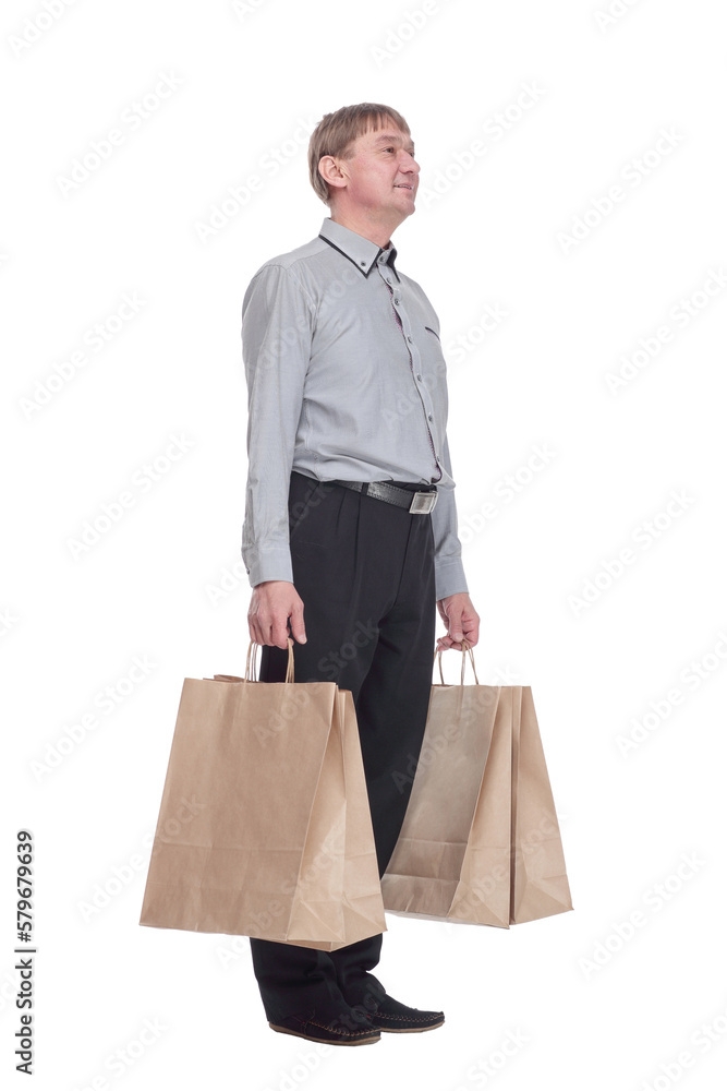 senior man with shopping bags reading the ad on a white screen . senior man with shopping bags reading the ad on a white screen .