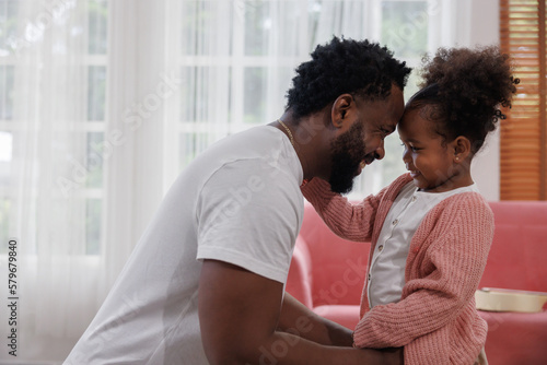 enjoy happy love black family african american father playing with his daughter little african girl child smiling and having fun moments good time. Happy father day concept.