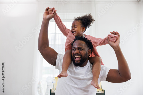 Принти на полотні enjoy happy love black family african american father carrying daughter little african girl child smiling and having fun moments good time