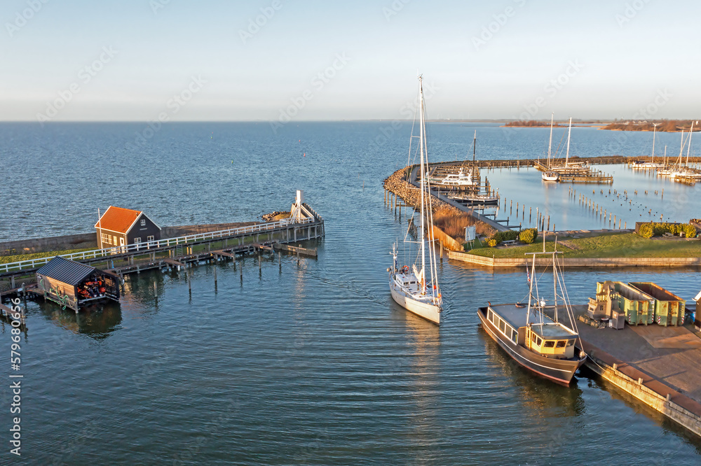 Aerial from sailingship arriving in the little harbor from Hindeloopen in Friesland the Netherlands - obrazy, fototapety, plakaty 