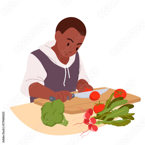 Boy cooking at home kitchen vector illustration. Cartoon cute little child chopping fresh tomato with knife on wooden board, young funny chef character cutting healthy vegetables for dinner or lunch