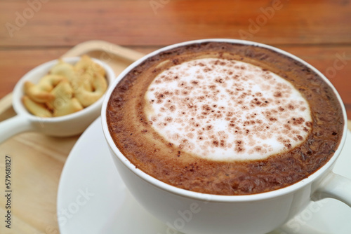 Cup of Cappuccino Coffee Served with Biscuits on Wooden