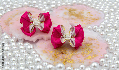 Fototapeta Naklejka Na Ścianę i Meble -  Satin ribbon hair bow made with your own hands, hair ornament for girls and women.