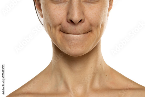 Photos Closeuo portrait of a woman with a tight lips gesture on a white background