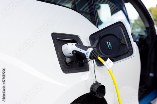 Gateshead UK: 26th Sept 2021: A hand-held closeup of an electric car on charge (EV, green sustainable travel)