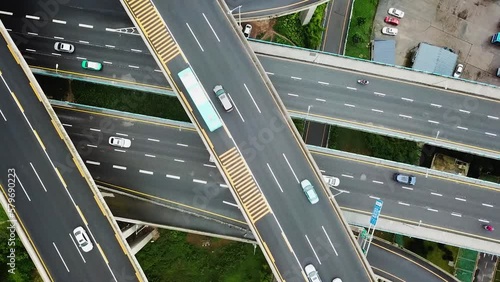 Aerial cenital shot of circular roads and highways floating five levels exchange in Chongqing and cars driving on them, Huangjuewan exchange. photo