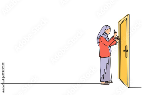Single one line drawing Arabian businesswoman lifts key in front of door. Woman holding key to open office room door. Starting morning with spirit to work. Continuous line draw design graphic vector