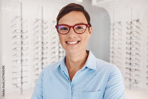 Come and test your eyes today for a clearer tomorrow. Portrait of a confident young woman working in an optometrists office.