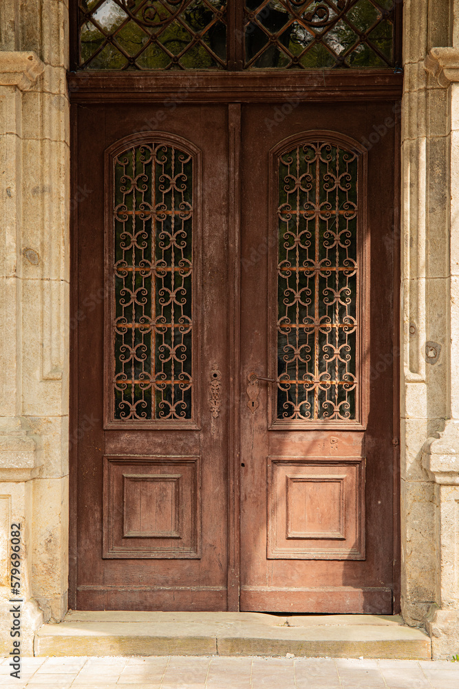 Old weathered wooden entry door of a rustic house