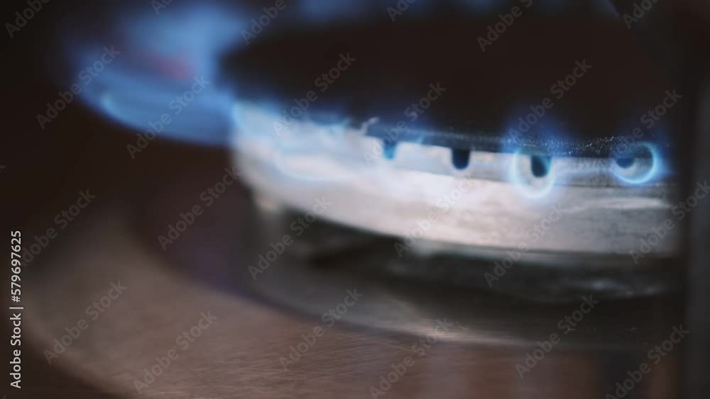 Setting fire of a gasring close up. Home gas stove burner starts to